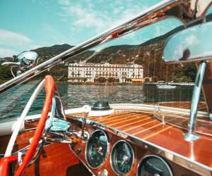 Exploring Lake Como aboard a classic wooden boat — a hallmark of Luxo Italia’s bespoke journeys.