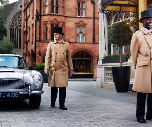 Doorman and Aston Martin DB5 outside The Connaught Hotel