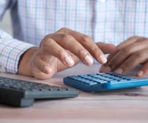 An accountant typing in his calculator