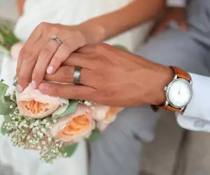 Close-up of a bride and groom's hands getting married