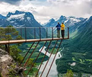 A couple overlooking an Alpine scene