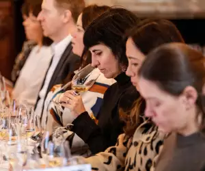 A lady tasting wine
